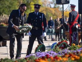 Casey Ward of the  Saskatchewan Federation of Police Officers lays a wreath during the annual Saskatchewan Police and Peace Officers Memorial outside of the Saskatchewan Legislative Building on  Sept. 25, 2022 in Regina.