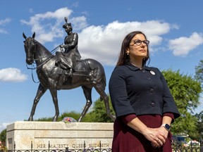 Monique Goffinet Miller, media liaison for the Monarchist League South Saskatchewan, stands in front of a statue of Queen Elizabeth II on Thursday.