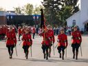 RCMP members carry the Royal Canadian Mounted Police guidon, draped in black in honour of the passing of Queen Elizabeth II,
during the annual National Memorial Service, which honours members of the force who have lost their lives in the line of duty.