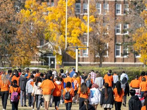 An event was held at the Residential School Memorial at Government House on the National Day for Truth and Reconciliation on Friday, September 30, 2022 in Regina. A sea of orange shirts walk back to Luther College High School after the event.