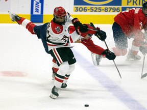 The Regina Pats' Corbin Vaughan and the Moose Jaw Warriors' Owen Berge, forefront, collide Friday night at the Brandt Centre.