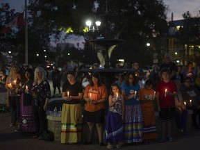 Mourners gather during a vigil for the victims of a mass stabbing that left 11 dead and 17 wounded in the communities of James Smith Cree Nation and Weldon on Wednesday, September 7, 2022 in Prince Albert.