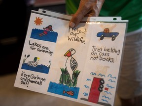 Rick Vigrass shows off a pamphlet made by a local association that promotes lake cleanup.