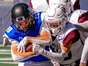 Branden Janotta, right, of the Regina Thunder tackles Winnipeg Rifles running back Brady Meeks during a Prairie Football Conference game in Winnipeg on Sept. 25.