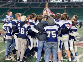 Members of the Balgonie Greenall Griffins hoist the Regina Intercollegiate Football League's Stewart Conference (5A) championship trophy at Mosaic Stadium after a 27-8 victory over the Sheldon-Williams Spartans on Thursday.