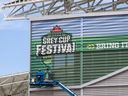 Crews work on installing a Grey Cup festival banner on the exterior of Mosaic Stadium on Wednesday, June 29, 2022 in Regina. The city is geared up for the November event, but many are wondering when a half-time preformer will be announced for the championship game.