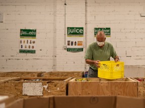 A volunteer sorts through food items at the Saskatoon Food Bank and Learning Centre in a Sept. 2021, handout photo. The executive director of the centre says more people in Saskatoon are struggling to get food for themselves and their families as the prices in grocery stores rise out of reach.