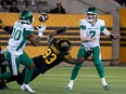 Saskatchewan Roughriders quarterback Cody Fajardo throws a short pass to Shaq Cooper in the face of pressure from the Hamilton Tiger-Cats' Malik Carney on Friday. Carney had three of Hamilton's seven sacks in its 18-14 victory.