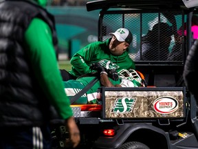 Saskatchewan Roughriders safety Mike Edem is assisted off the field after sustaining an injury during Saturday's fourth quarter at Mosaic Stadium.