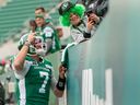 Saskatchewan Roughriders quarterback Cody Fajardo poses for a photo with a young fan before Saturday's game against the Calgary Stampeders at Mosaic Stadium.