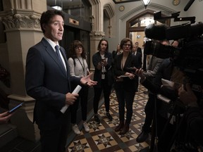 Prime Minister Justin Trudeau speaks with reporters before attending caucus on Parliament Hill, Wednesday, October 19, 2022 in Ottawa.