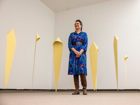 Curatorial Fellow Felicia Gay, who curated a retrospective exhibition on the career of contemporary artist Faye Heavishield, stands next to an installation at Mackenzie Art Gallery Thursday, Oct. 20, 2022, in Regina.