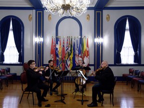 Regina Symphony Orchestra members Christian Robinson, Heng Han Hou, Simon Fryer and Jonathan Ward, from left, rehearse at Government House. Each plays an instrument from the 1600s.