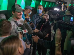 Cody Fajardo (middle) was the centre of media attention while the Saskatchewan Roughriders cleaned out their lockers on Sunday.