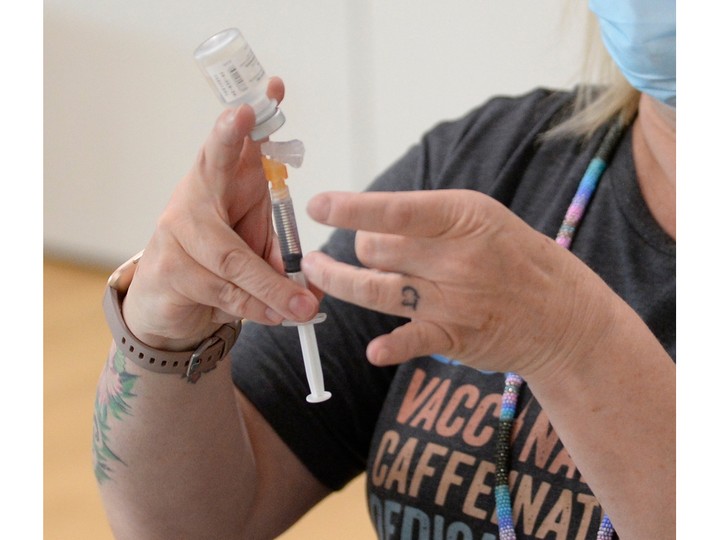  Public health nurse Joy Haroldson prepares a syringe of Pfizer COVID-19 vaccine at the mâmawêyatitân centre in Regina, Saskatchewan on May 31, 2021.