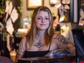 18-year-old tattoo artist Taylor Hall stands at the counter at InDepth Tattoos & Design in Regina on Monday, September 26, 2022.