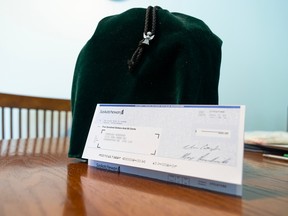 A $500 cheque addressed to a deceased Saskatoon resident stands next to his ashes.