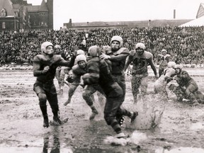 Game action from the 1950 Grey Cup game (aka the Mud Bowl), between the Toronto Argonauts and the Winnipeg Blue Bombers. Photo courtesy of the Canadian Football Hall of Fame and Museum.