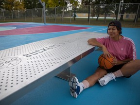 Brianna LaPlante is shown at The Yard — the outdoor basketball courts at Regent Park. She did the artwork for the courts as part of the Buckets & Borders initiative.