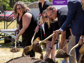 YWCA Regain CO Melissa Coomber-Bendtsen, left, turns over soil during a groundbreaking ceremony for the YWCA's new Centre For Women and Families in Regina in June.