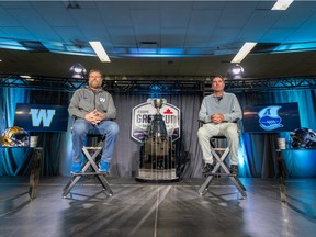 Winnipeg Blue Bombers head coach Mike O'Shea, left, and Toronto Argonauts head coach Ryan Dinwiddie sit during the head coaches' media conference ahead of the Grey Cup at the Queensbury Convention Centre