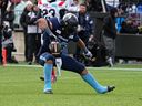 Toronto Argonauts berlari kembali Andrew Harris merayakan lari touchdown enam yard di final Divisi Timur hari Minggu melawan Montreal Alouettes.