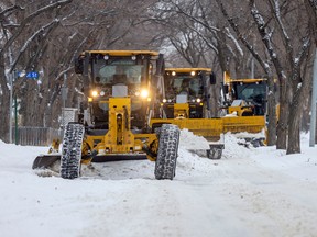 Road graders clear snow from Victoria Avenue west of Albert Street on Tuesday.