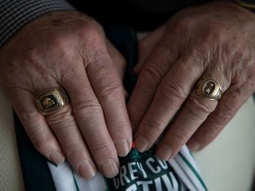 Dale West, who in 1966 played on the Saskatchewan Roughriders' first Grey Cup-winning team, shows his Grey Cup ring (right) and his Plaza of Honour ring (left) at his home on Thursday. KAYLE NEIS / Regina Leader-Post