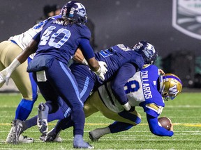 Winnipeg Blue Bombers quarterback Zach Collaros is sacked by the Toronto Argonauts' Shawn Oakman in the 109th Grey Cup game, played at Mosaic Stadium on Nov. 20.