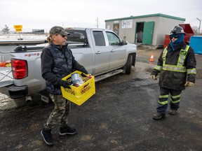 Ellis Johnson, left, drops off some household materials during the  grand opening of the new Household Hazardous Materials Depot at the City of Regina Landfill on Monday, November 21, 2022 in Regina.