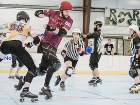 Anastasia Oborotova (center) has been refereeing roller derby for as long as she's been skating and regularly contributes her expertise in the Saskatchewan league. (Courtesy of ANASTASSIA OBOROTOVA/ANJA WINTERGREEN)