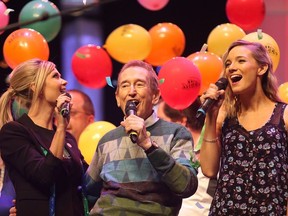 Beverley Mahood, left, Bob McGrath and Leah Daniels sing during McGrath's last Telemiracle telethon at TCU Place in Saskatoon on March 8, 2015.