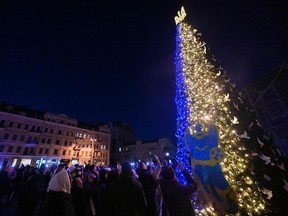 People take selfie photographs during the unveiling ceremony of Kyiv's main Christmas tree on St. Sophia Square in the Ukrainian capital of Kyiv, on Dec. 19, 2022.