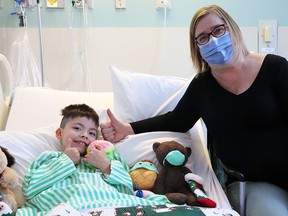 Judy Henley, President of CUPE Saskatchewan, offers a comforting plush toy to Aiden Tessmer, one of the many pediatric patients at Regina General Hospital. PHOTO: NATHAN MARKWART