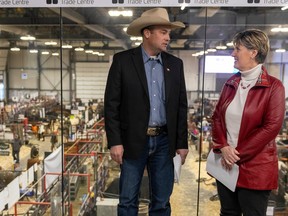 Ryan Beierbach, left, director of the Canadian Cattle Association, speaks with Marie-Claude Bibeau, federal Minister of Agriculture and Agri-Food, at Canadian Western Agribition on Saturday.