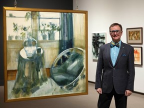 MacKenzie Art Gallery head curator Timothy Long stands beside a double sided painting in the Anthony Thorn: A Portrait, 1927–2014 exhibit on Wednesday, December 7, 2022 in Regina.