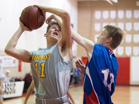 The LeBoldus Golden Suns' Connor Morley, left, and Swift Current Colts' Tristen Urquhart-Nelson are shown in a senior boys game at the 2018 Fekula Senior Classic basketball tournament at Balfour Collegiate. This year's tournament runs from Thursday to Saturday.