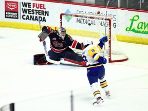 The Saskatoon Blades' Brandon Lisowsky scores against Regina Pats goaltender Drew Sim on Saturday at the Brandt Centre.