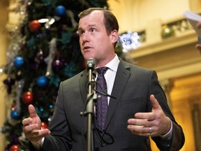 Trent Wotherspoon speaks in the rotunda of the Legislative Building on Monday.