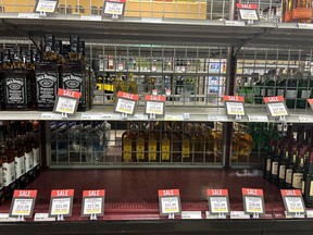 Shelves marked with sale signs at the Victoria East liquor store on Monday, December 12, 2022 in Regina.