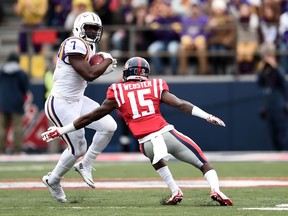 Kendarius Webster of the University of Mississippi Rebels attempts to tackle LSU Tigers running back Leonard Fournette on Nov. 21, 2015 in Oxford, Miss. Webster has signed with the Saskatchewan Roughriders.