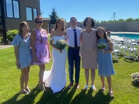 Big Brothers Big Sisters partners Amber Froehlich (from left to right), Shayla Froehlich, older sister Amarha, Trae, mother Pam and Kaylee pose for a photo at a family wedding.