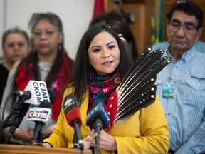Opposition First Nation Metis Relations critic Betty Nippi-Albright holds eagle feathers as First Nations people demand honest dialogue of Crown land leasing.