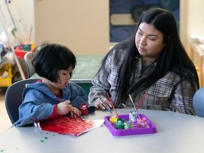 Asisten guru Shaelynne Anaskan bekerja dengan seorang anak di The Regina Early Learning Center pada Rabu, 18 Januari 2023 di Regina.