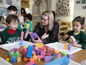 Executive director Monica Totton speaks with children doing crafts at The Regina Early Learning Centre  on Wednesday, January 18, 2023 in Regina.