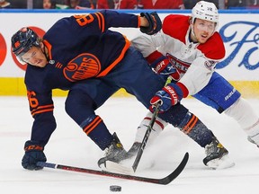 Edmonton Oilers defencemen Philip Broberg (86) and Montreal Canadiens forward Rem Pitlick (32) battle for a loose puck during the second period at Rogers Place on March 5, 2022.