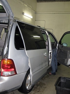 An officer with the Regina Integrated Drug Unit looks inside a van stopped in Salmon Arm, B.C. on Oct. 1, 2011.