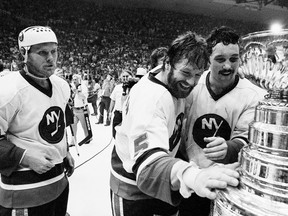 New York Islanders players Butch Goring, left, Denis Potvin, centre, and Bryan Trottier celebrate the team's Stanley Cup victory on May 24, 1980. Goring had joined the Islanders 2 1/2 months earlier in a trade-deadline deal with the Los Angeles Kings. Goring proceeded to help the Islanders win four consecutive Stanley Cups.