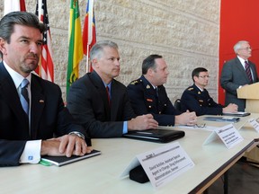 Michael Cotter (R) with the US Attorney’s Office in Helena, Montana speaks at a media conference at the RCMP Heritage Centre in Regina on Oct 25, 2011 regarding one of the largest controlled drug seizures in the history of the Saskatchewan RCMP.
