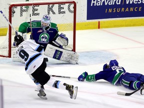 Zach Benson of the Winnipeg Ice is shown at the Brandt Centre on March 15, 2021 — scoring his first WHL goal. The Swift Current Broncos' Isaac Poulter is in net.
